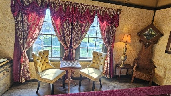 Vintage sitting area with patterned curtains and chairs