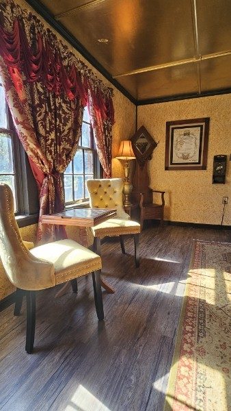 Vintage sitting area with tufted chairs and sunny windows