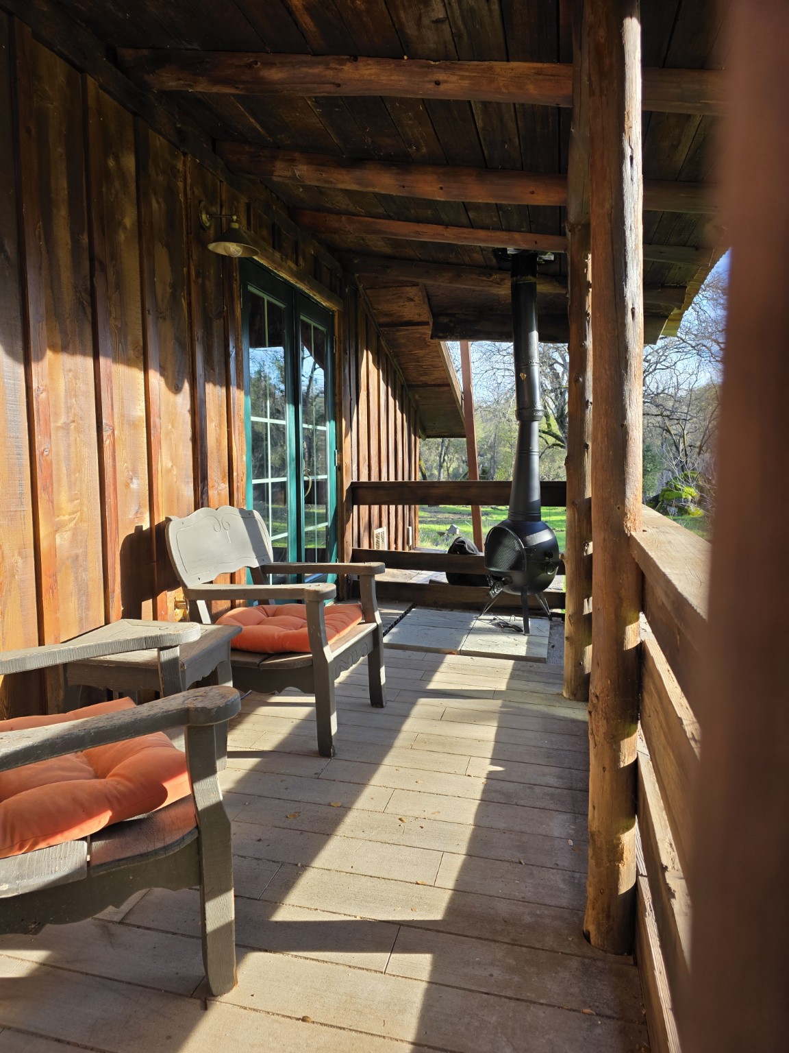Covered porch running along the cabin