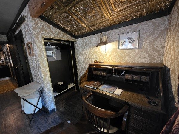 Detailed view of the writing desk beneath the ornate ceiling